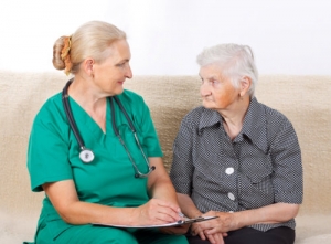 caregiver and an elder woman talking